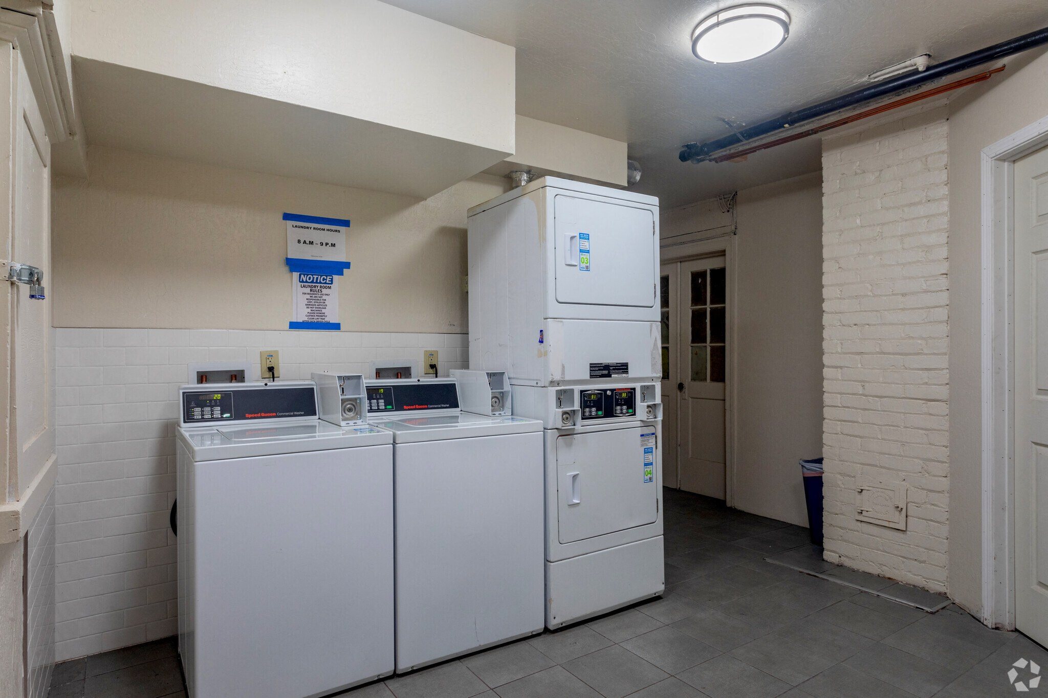 a laundry room with two washes and two refrigerators in it